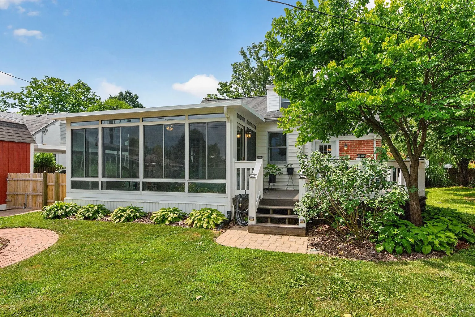 Fenced backyard with lawn and storage shed